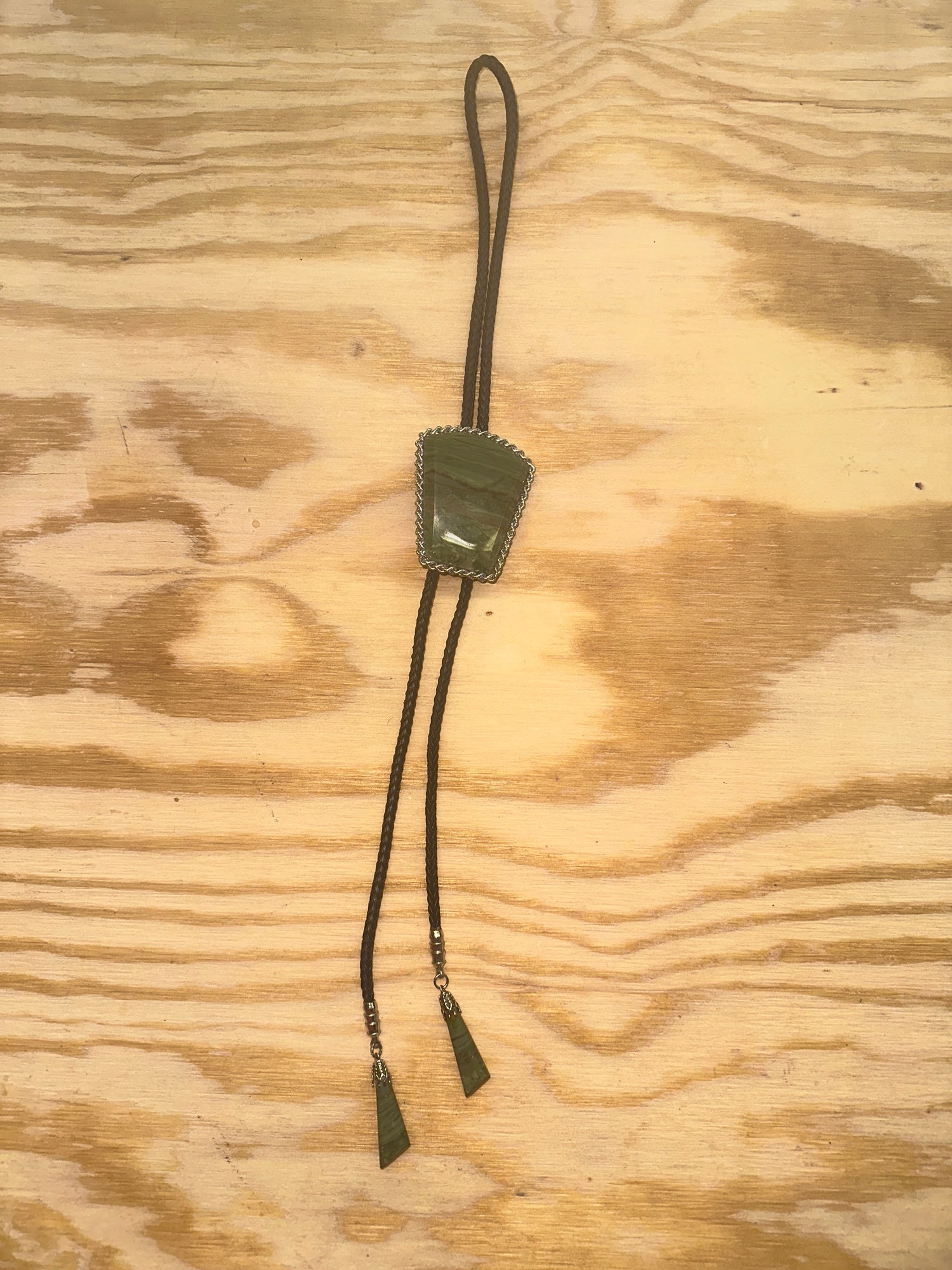 Green Bolo tie on leather